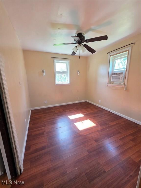 719 Clark St, Philo, OH 43771 - empty room with healthy amount of natural light, wood finished floors, a ceiling fan, and baseboards
