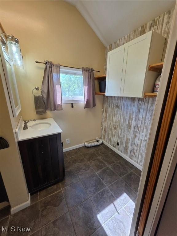 719 Clark St, Philo, OH 43771 - bathroom with vaulted ceiling, vanity, and baseboards
