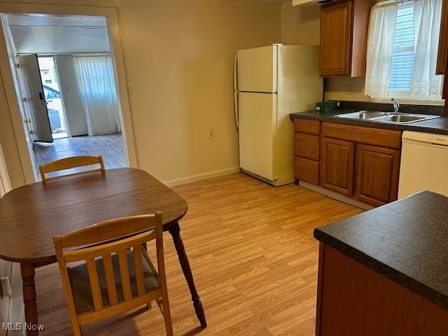 1131 Windermere Dr, Willoughby, OH 44094 - kitchen featuring a sink, white appliances, dark countertops, and brown cabinetry