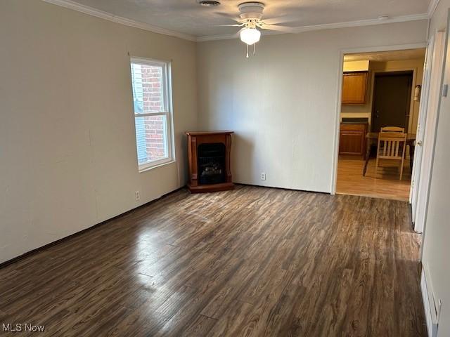 1131 Windermere Dr, Willoughby, OH 44094 - unfurnished room with dark wood-type flooring, ceiling fan, ornamental molding, and a fireplace