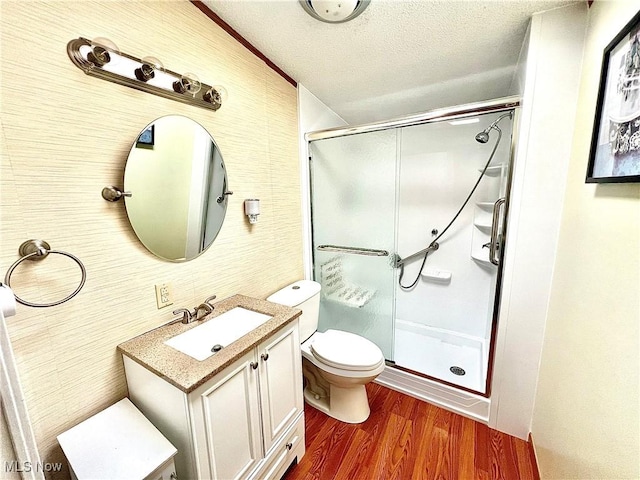 115 Rhodes Ave, Dillonvale, OH 43917 - bathroom featuring vanity, a shower stall, toilet, a textured ceiling, and wood finished floors