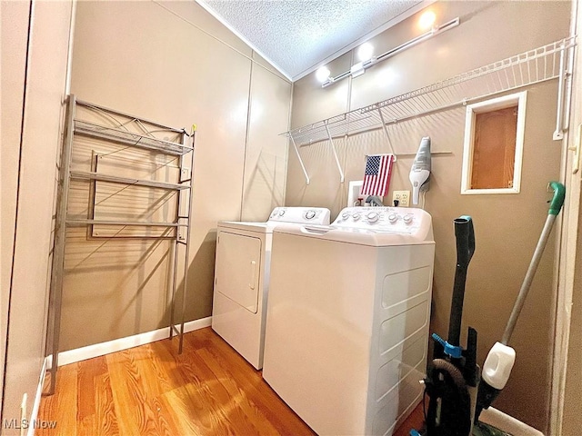 115 Rhodes Ave, Dillonvale, OH 43917 - laundry room with independent washer and dryer, wood finished floors, a textured ceiling, and baseboards
