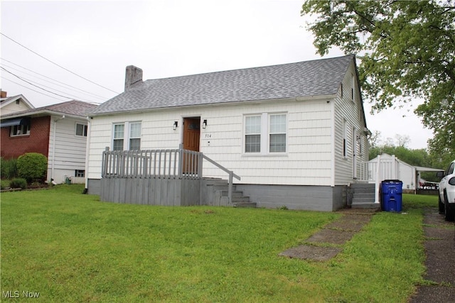 504 Williams Ave, East Liverpool, OH 43920 - view of front of property featuring roof with shingles, a front yard, and a chimney