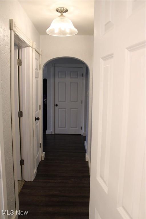 504 Williams Ave, East Liverpool, OH 43920 - hallway with arched walkways and dark wood-type flooring