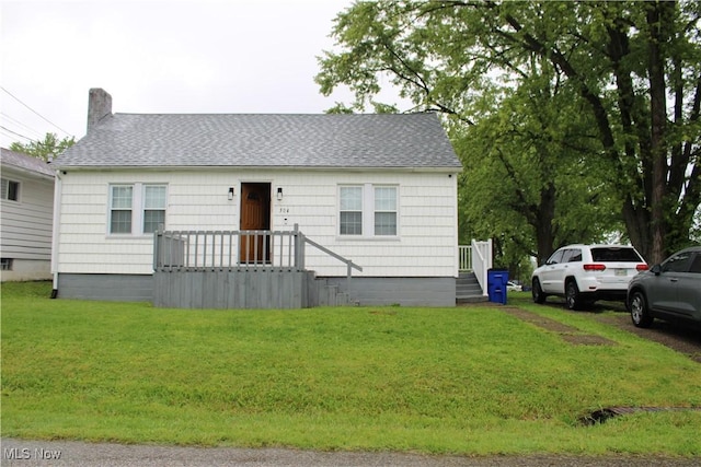 504 Williams Ave, East Liverpool, OH 43920 - view of front of house with a shingled roof, a front lawn, and a chimney