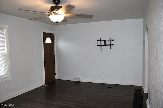 504 Williams Ave, East Liverpool, OH 43920 - unfurnished room with dark wood finished floors, ceiling fan, arched walkways, and healthy amount of natural light