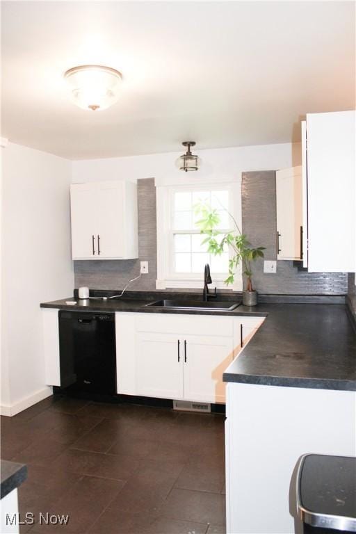 504 Williams Ave, East Liverpool, OH 43920 - kitchen featuring dishwasher, a sink, dark countertops, backsplash, and white cabinetry