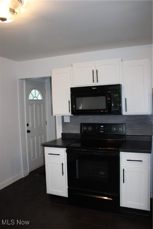 504 Williams Ave, East Liverpool, OH 43920 - kitchen featuring black appliances, dark countertops, tasteful backsplash, and white cabinets