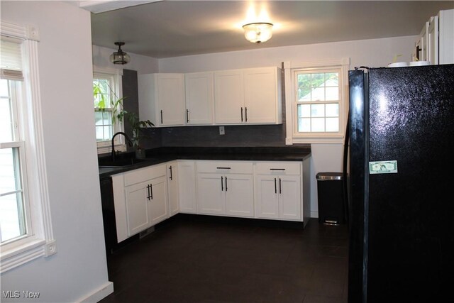 504 Williams Ave, East Liverpool, OH 43920 - kitchen with freestanding refrigerator, a sink, white cabinets, dark countertops, and decorative backsplash