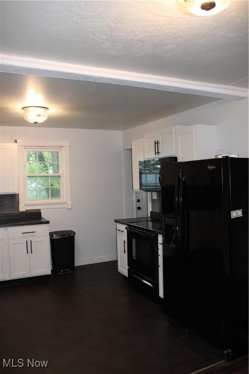 504 Williams Ave, East Liverpool, OH 43920 - kitchen with black appliances, dark countertops, white cabinetry, baseboards, and a textured ceiling