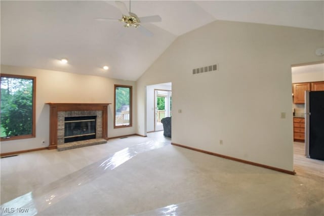 28420 Glen Hollow Ln, Olmsted Falls, OH 44138 - unfurnished living room featuring a glass covered fireplace, light carpet, high vaulted ceiling, ceiling fan, and baseboards