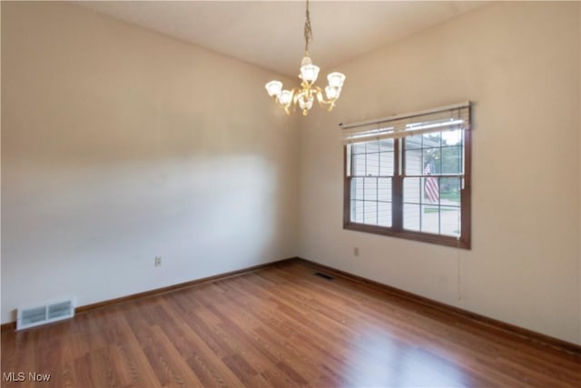 28420 Glen Hollow Ln, Olmsted Falls, OH 44138 - empty room featuring wood finished floors, a chandelier, and baseboards