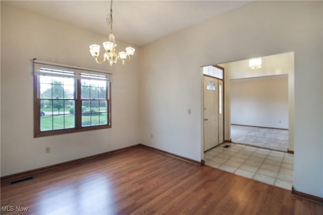 28420 Glen Hollow Ln, Olmsted Falls, OH 44138 - spare room featuring a chandelier, baseboards, and wood finished floors