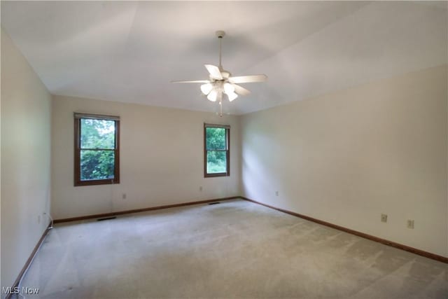 28420 Glen Hollow Ln, Olmsted Falls, OH 44138 - spare room featuring healthy amount of natural light, light colored carpet, a ceiling fan, and baseboards