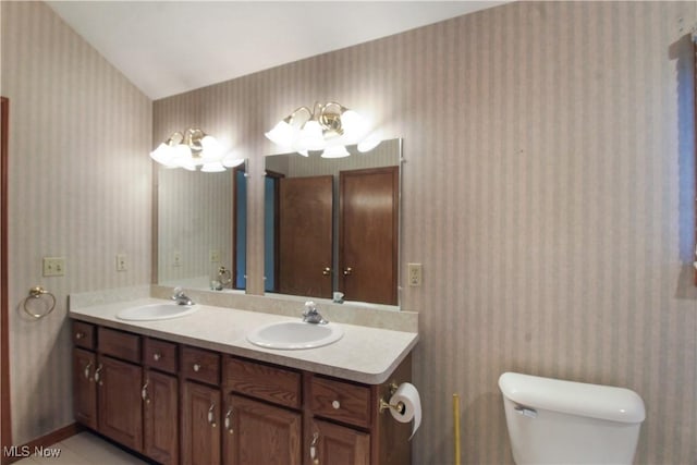 28420 Glen Hollow Ln, Olmsted Falls, OH 44138 - full bathroom featuring wallpapered walls, double vanity, and toilet