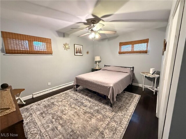 250 Crystal Ln, Weirton, WV 26062 - bedroom featuring a baseboard heating unit, baseboards, dark wood finished floors, and ceiling fan