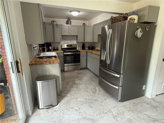 250 Crystal Ln, Weirton, WV 26062 - kitchen featuring appliances with stainless steel finishes, gray cabinetry, butcher block counters, a sink, and light marble finish floors