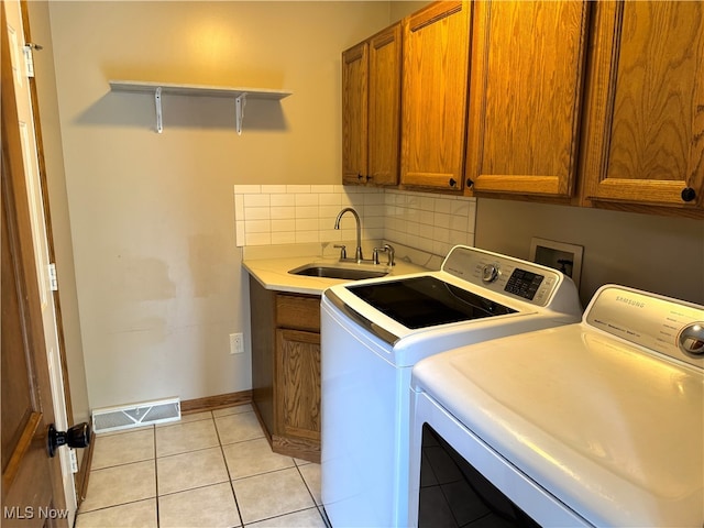 2761 Timberline Dr, Cortland, OH 44410 - laundry room with cabinet space, independent washer and dryer, light tile patterned flooring, and baseboards