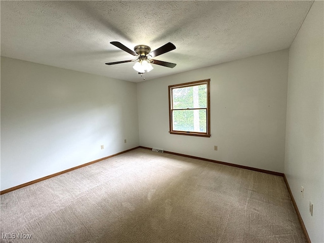 2761 Timberline Dr, Cortland, OH 44410 - spare room featuring light carpet, a ceiling fan, baseboards, and a textured ceiling