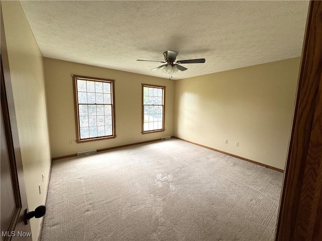 2761 Timberline Dr, Cortland, OH 44410 - empty room featuring a ceiling fan, carpet floors, baseboards, and a textured ceiling