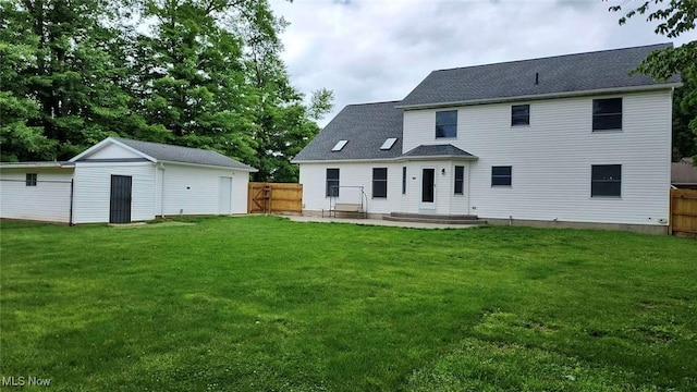 2761 Timberline Dr, Cortland, OH 44410 - rear view of house featuring an outdoor structure, a patio, and a shingled roof