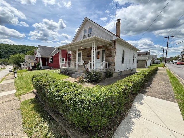 333 Heaslett Ave, Weirton, WV 26062 - view of front facade featuring covered porch and a chimney