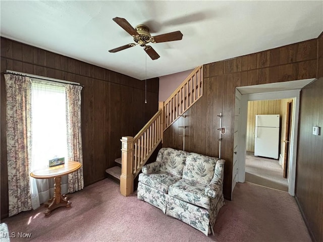 333 Heaslett Ave, Weirton, WV 26062 - living room featuring wood walls, stairway, carpet floors, and ceiling fan