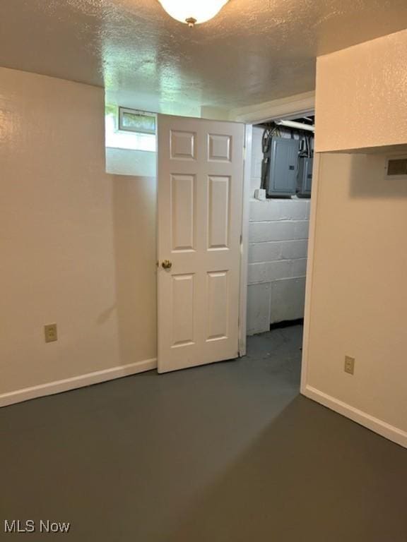 20806 Watson Rd, Maple Heights, OH 44137 - below grade area with electric panel, a textured ceiling, and baseboards