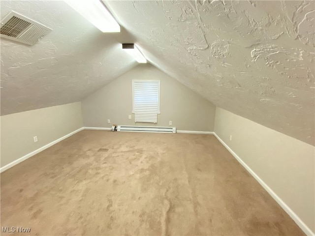 4485 Baintree Rd, University Heights, OH 44118 - additional living space featuring baseboard heating, baseboards, lofted ceiling, a textured ceiling, and carpet flooring