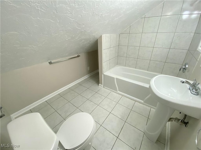4485 Baintree Rd, University Heights, OH 44118 - full bath with a textured ceiling, toilet, baseboards, a tub, and tile patterned flooring