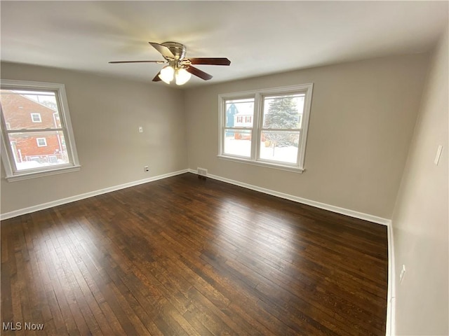 4485 Baintree Rd, University Heights, OH 44118 - empty room with dark wood-style flooring, a ceiling fan, and baseboards