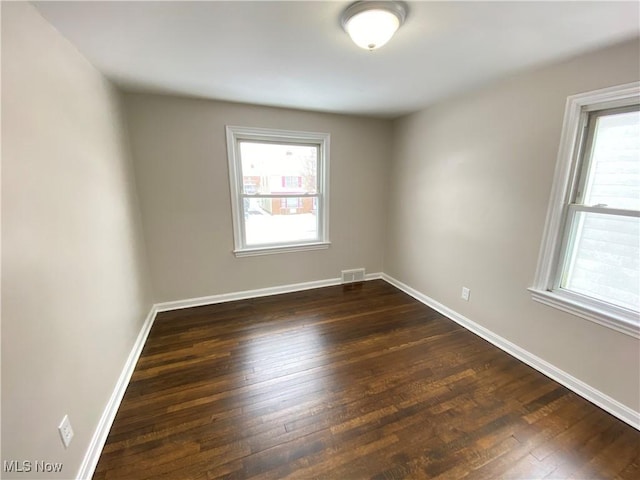 4485 Baintree Rd, University Heights, OH 44118 - empty room featuring healthy amount of natural light, dark wood-style flooring, and baseboards