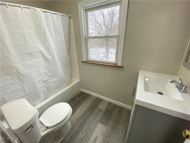 4485 Baintree Rd, University Heights, OH 44118 - full bathroom with toilet, vanity, wood finished floors, baseboards, and shower / bath combination with curtain