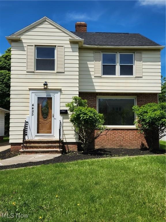 4485 Baintree Rd, University Heights, OH 44118 - view of front of property with a front lawn, entry steps, a chimney, and brick siding