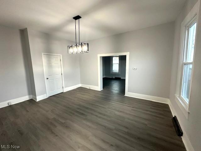 1264 Linden Ave, Zanesville, OH 43701 - unfurnished dining area featuring dark wood-style flooring and baseboards