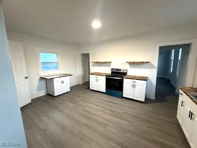 1264 Linden Ave, Zanesville, OH 43701 - kitchen with stainless steel range with electric cooktop, open shelves, dark wood finished floors, white cabinets, and butcher block counters