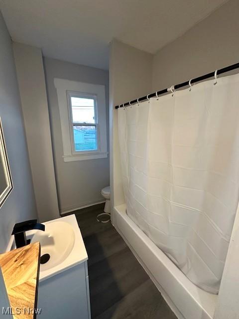 1264 Linden Ave, Zanesville, OH 43701 - bathroom with vanity, wood finished floors, toilet, and shower / bath combo
