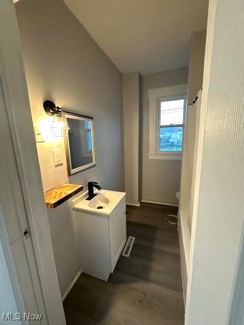 1264 Linden Ave, Zanesville, OH 43701 - bathroom with vanity, wood finished floors, baseboards, and toilet