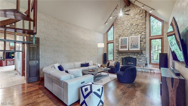 5360 Som Center Rd, Solon, OH 44139 - living area with track lighting, high vaulted ceiling, wood finished floors, and a stone fireplace