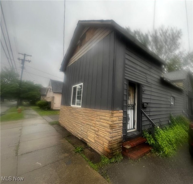 3810 E 54th St, Cleveland, OH 44105 - view of property exterior with entry steps and stone siding