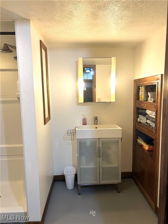 1214 Wentworth Ave, Toronto, OH 43964 - full bath with vanity, a textured ceiling, finished concrete flooring, baseboards, and a shower