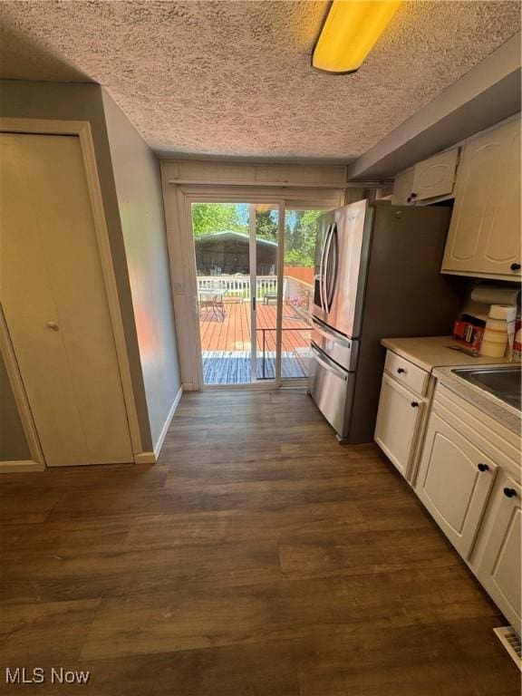 4940 State Route 26, Marietta, OH 45750 - kitchen with a sink, white cabinetry, a textured ceiling, dark wood finished floors, and stainless steel fridge with ice dispenser
