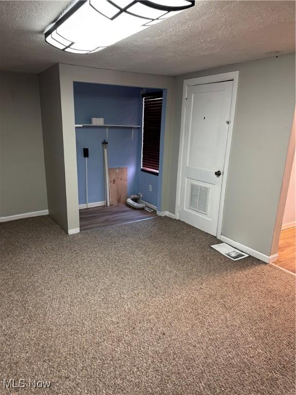 4940 State Route 26, Marietta, OH 45750 - finished basement featuring a textured ceiling, carpet floors, and baseboards