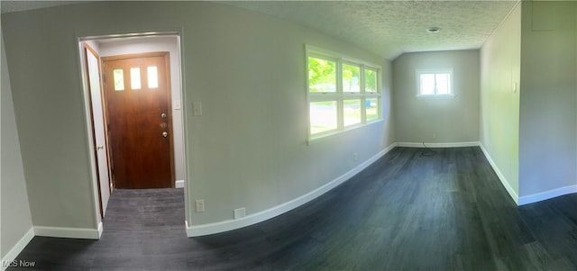2824 Brenner Dr, Lorain, OH 44053 - entrance foyer with dark wood finished floors, baseboards, vaulted ceiling, and a textured ceiling