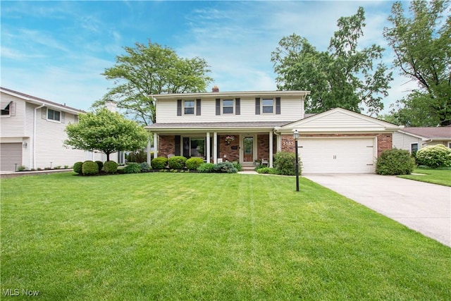 3565 Chrisfield Dr, Rocky River, OH 44116 - traditional home with a porch, a garage, concrete driveway, a front yard, and brick siding
