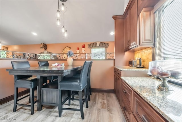13817 Lakewood Heights Blvd, Lakewood, OH 44107 - dining area featuring light wood-style floors and baseboards