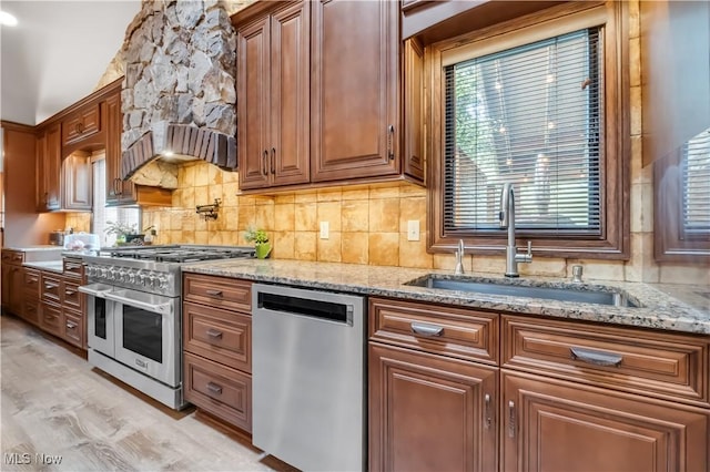 13817 Lakewood Heights Blvd, Lakewood, OH 44107 - kitchen featuring stainless steel appliances, a sink, light stone countertops, and healthy amount of natural light