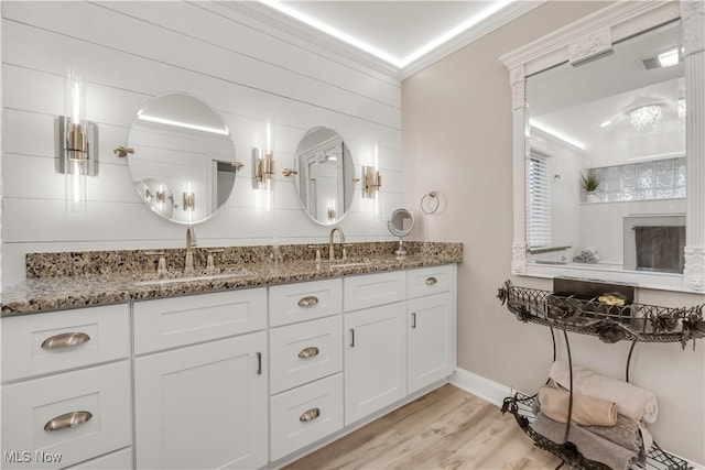 13817 Lakewood Heights Blvd, Lakewood, OH 44107 - bathroom featuring double vanity, wood finished floors, crown molding, and baseboards