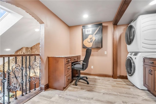 13817 Lakewood Heights Blvd, Lakewood, OH 44107 - office featuring stacked washing machine and dryer, light wood-type flooring, baseboards, arched walkways, and recessed lighting