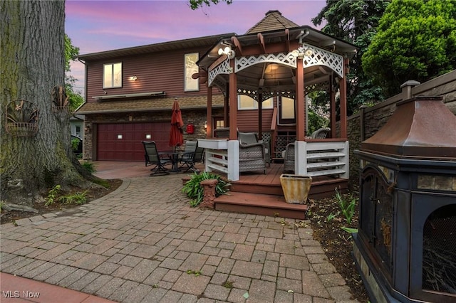 13817 Lakewood Heights Blvd, Lakewood, OH 44107 - view of patio / terrace featuring an attached garage, a gazebo, driveway, outdoor dining area, and a deck